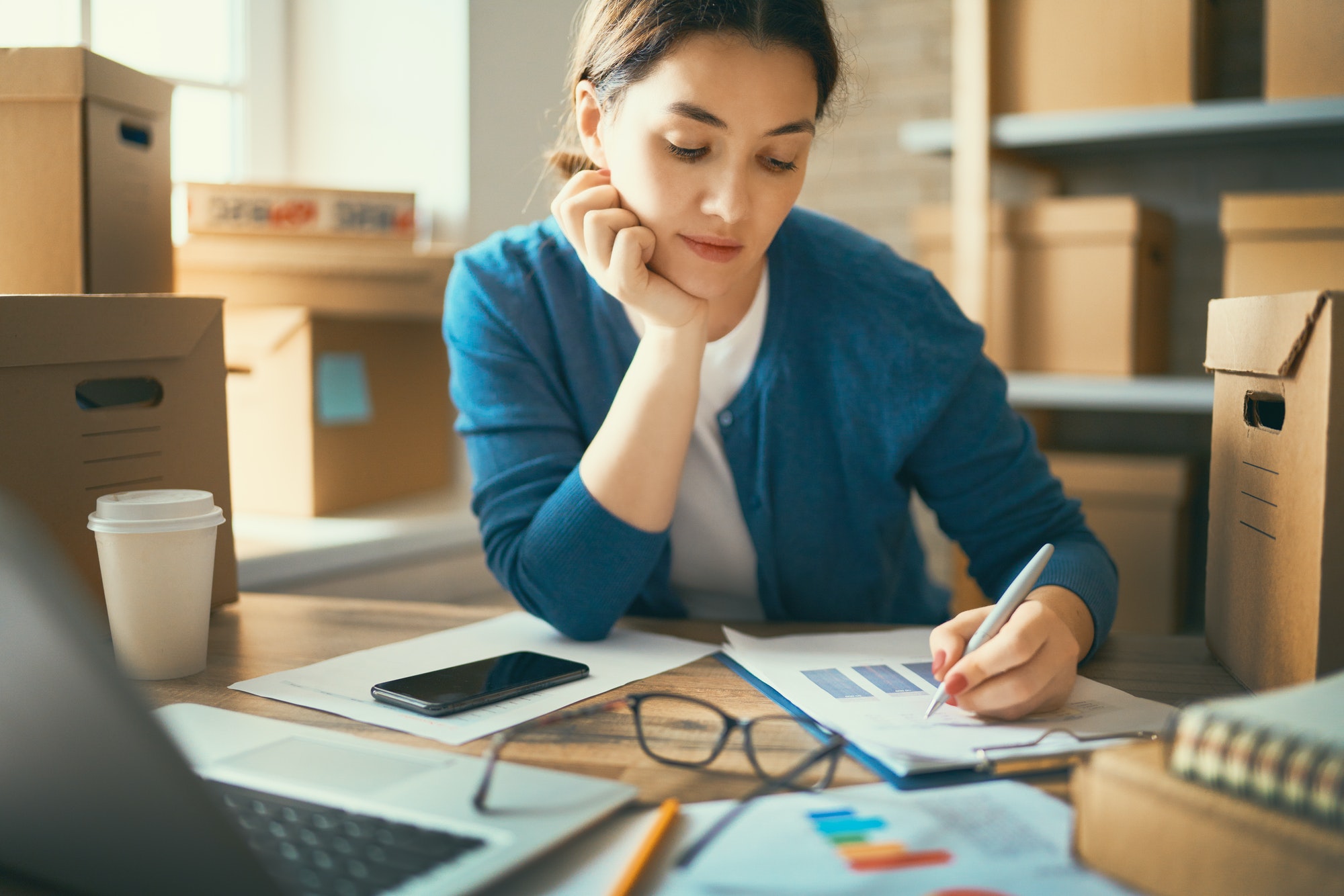 Woman is working at warehouse for online store.